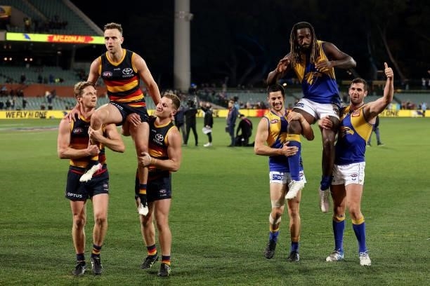 Brodie Smith of the Crows and Nic Naitanui of the Eagles are chaired off after their 200th games during the 2021 AFL Round 18 match between the...