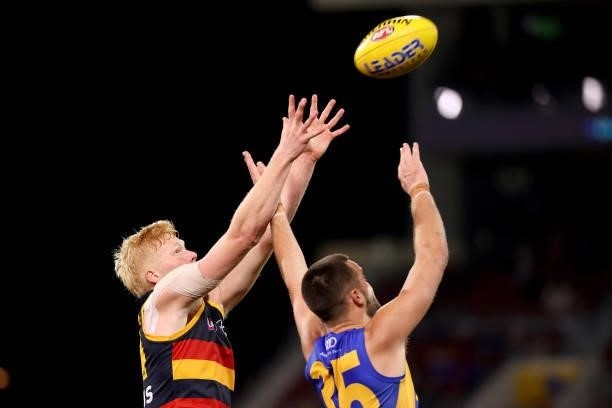 Elliott Himmelberg of the Crows competes with Josh Rotham of the Eagles during the 2021 AFL Round 18 match between the Adelaide Crows and the West...