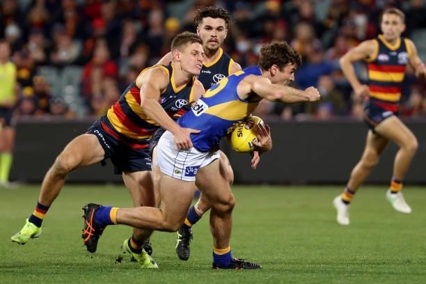 David Mackay of the Crows tackles Jamie Cripps of the Eagles during the 2021 AFL Round 18 match between the Adelaide Crows and the West Coast Eagles...