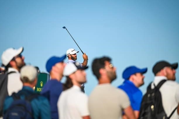 Dustin Johnson plays his shot from the 16th tee as fans watch during Day Two of the 149th The Open Championship at Royal St. Georges Golf Club on...