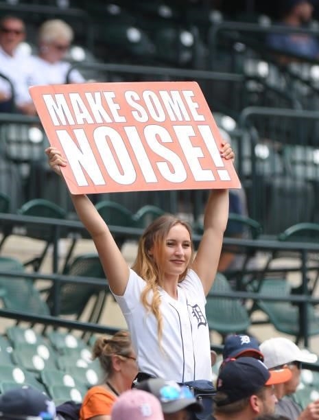 Member of the Comerica Park Energy Squad holds up a sign to fire up the fans during game one of a doubleheader between the Detroit Tigers and the...