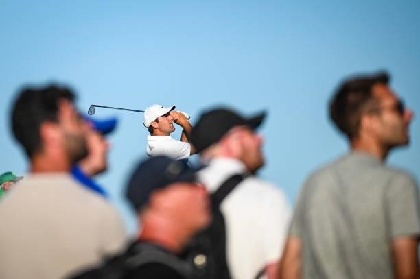 Scottie Scheffler plays his shot from the 16th tee as fans watch during Day Two of the 149th The Open Championship at Royal St. Georges Golf Club on...