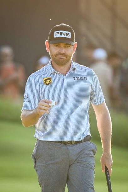 Louis Oosthuizen of South Africa waves his ball to fans after making a birdie putt on the 16th hole green during Day Two of the 149th The Open...
