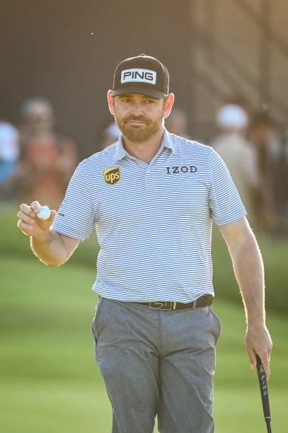 Louis Oosthuizen of South Africa waves his ball to fans after making a birdie putt on the 16th hole green during Day Two of the 149th The Open...