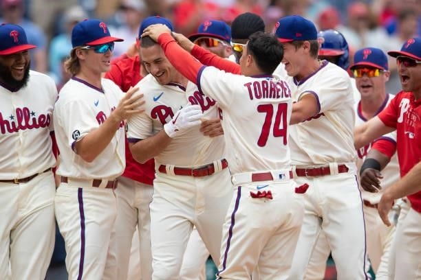 Realmuto of the Philadelphia Phillies celebrates with his teammates after hitting a walk-off two-run home run in the bottom of the tenth inning...