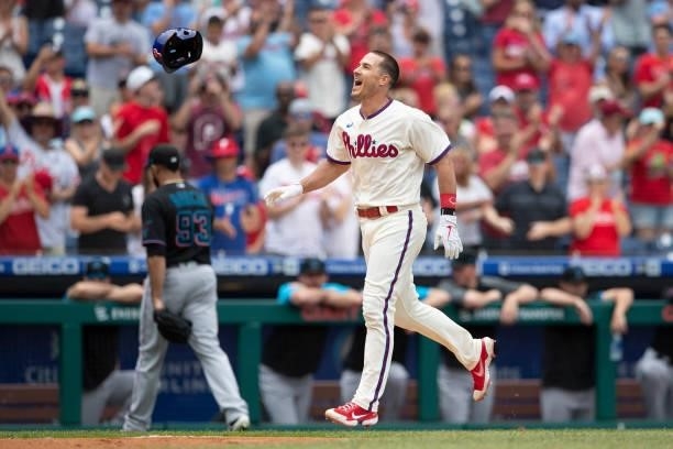 Realmuto of the Philadelphia Phillies reacts in front of Yimi Garcia of the Miami Marlins after hitting a walk-off two-run home run in the bottom of...