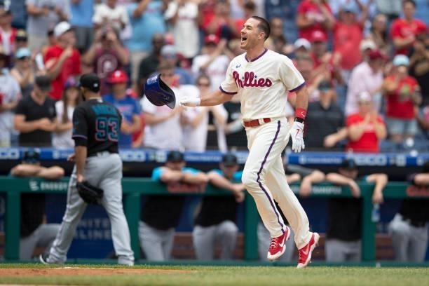 Realmuto of the Philadelphia Phillies reacts in front of Yimi Garcia of the Miami Marlins after hitting a walk-off two-run home run in the bottom of...