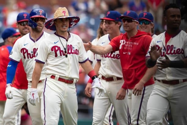 Realmuto of the Philadelphia Phillies celebrates with his teammates after hitting a walk-off two-run home run in the bottom of the tenth inning...