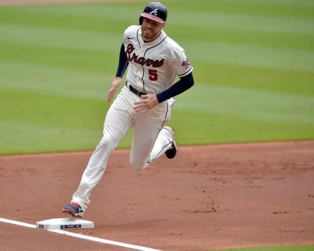 Freddie Freeman of the Atlanta Braves rounds third base after an Ozzie Albies double in the first inning against the Tampa Bay Rays at Truist Park on...