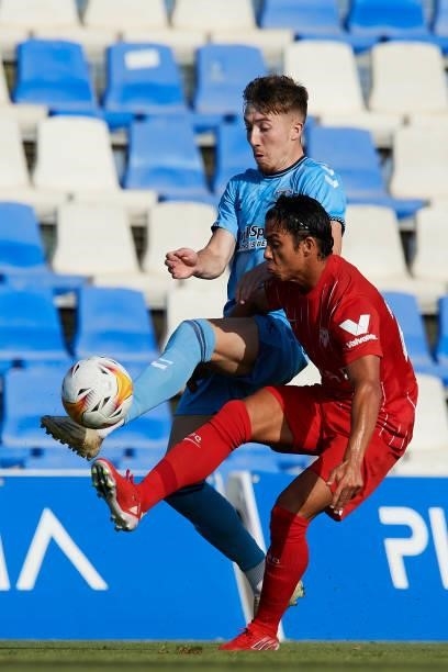 Oliver Torres of Sevilla and Jordan Shipley of Coventry City compete for the ball during the pre-season friendly match between Sevilla CF and...