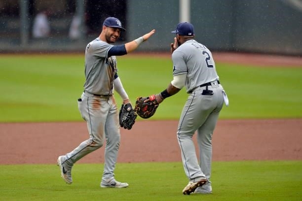 Kevin Kiermaier and Yandy Díaz of the Tampa Bay Rays celebrate their win over the Atlanta Braves at Truist Park on July 18, 2021 in Atlanta, Georgia.