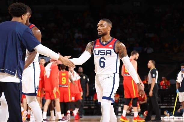 Damian Lillard of the USA Men's National Team high fives Keldon Johnson of the USA Men's National Team during the game against the Spain Men's...