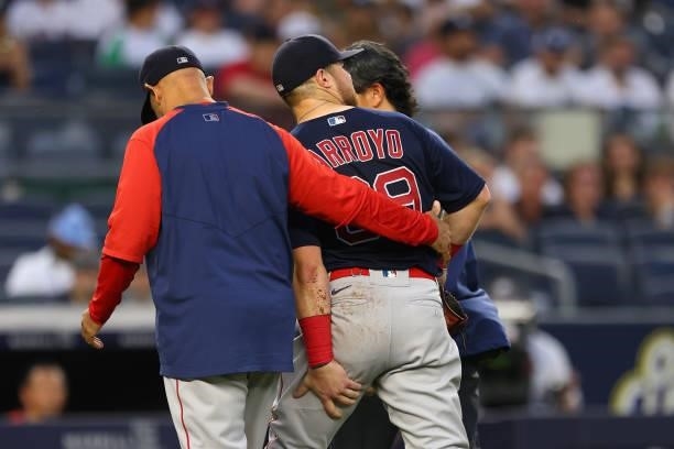 Christian Arroyo of the Boston Red Sox is helped off the field after suffering an injury against the New York Yankees during the third inning of a...