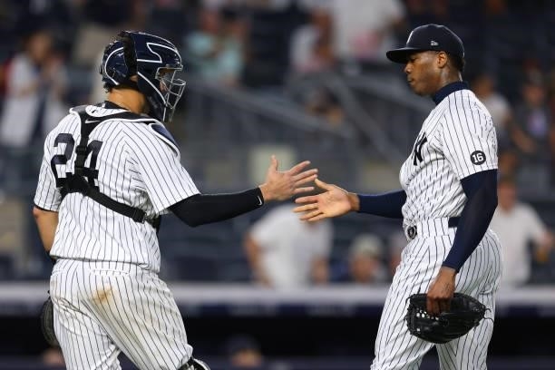 Closer Aroldis Chapman and catcher Gary Sanchez of the New York Yankees shakes hands after defeating the Boston Red Sox 9-1 at Yankee Stadium on July...