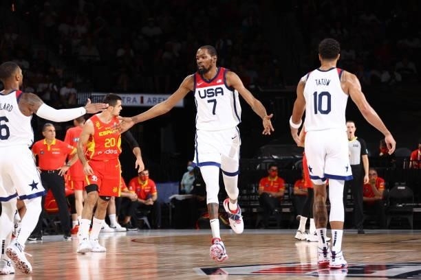 Kevin Durant of the USA Men's National Team high fives Damian Lillard of the USA Men's National Team and Jayson Tatum of the USA Men's National Team...