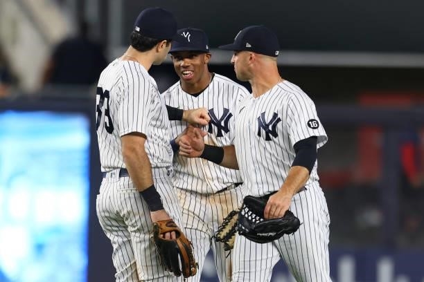 Outfielders Ryan LaMarre, Greg Allen and Brett Gardner of the New York Yankees celebrate after defeating the Boston Red Sox 9-1 at Yankee Stadium on...
