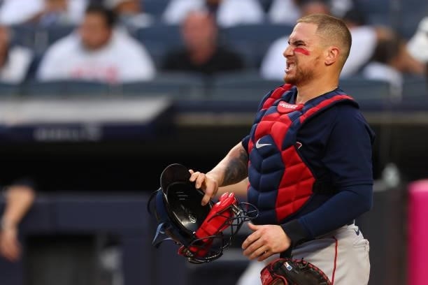 Catcher Christian Vázquez of the Boston Red Sox grimaces after being hit by a foul ball in the second inning against the New York Yankees at Yankee...