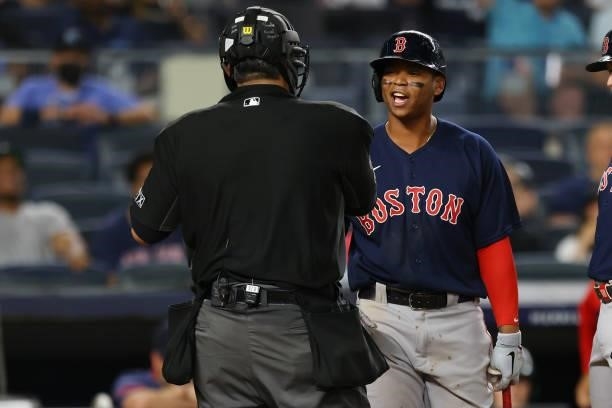 Rafael Devers of the Boston Red Sox argues a called third strike with home plate umpire Manny Gonzalez in the sixth inning against the New York...