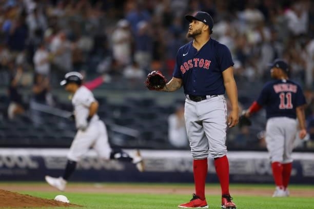 Pitcher Darwinzon Hernandez of the Boston Red Sox waits for a new ball as Rougned Odor of the New York Yankees circles the bases on his home run in...