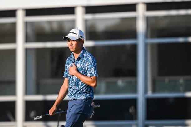 Collin Morikawa puts his hand over his heart to acknowledge fans as he walks to the 18th hole green during Day Four of the 149th The Open...