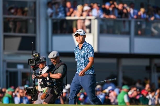Collin Morikawa smiles as he walks to the 18th hole green during Day Four of the 149th The Open Championship at Royal St. Georges Golf Club on July...
