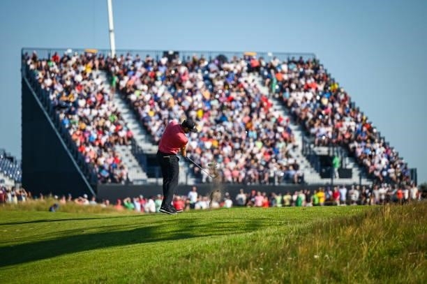 Corey Conners of Canada plays his second shot on the 17th hole fairway as fans watch from a grandstand during Day Four of the 149th The Open...