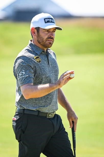Louis Oosthuizen of South Africa waves his ball to fans after making a par putt on the first hole during Day Four of the 149th The Open Championship...
