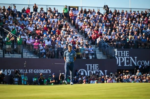 Collin Morikawa reacts and smiles after just missing a birdie putt on the 18th hole green as fans watch from the grandstand during Day Four of the...