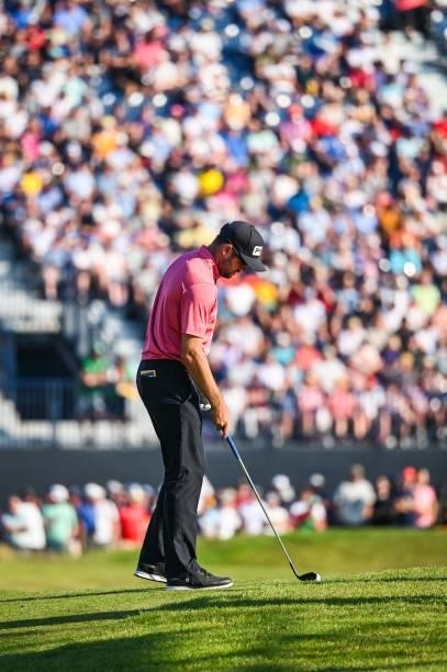 Corey Conners of Canada prepares to hit his second shot on the 17th hole fairway as fans watch from a grandstand during Day Four of the 149th The...