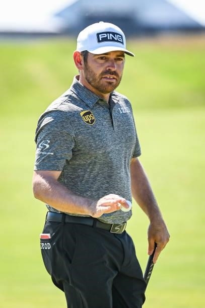 Louis Oosthuizen of South Africa waves his ball to fans after making a par putt on the first hole during Day Four of the 149th The Open Championship...