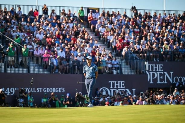 Collin Morikawa kicks his leg to react to just missing a birdie putt on the 18th hole green as fans watch from the grandstand during Day Four of the...