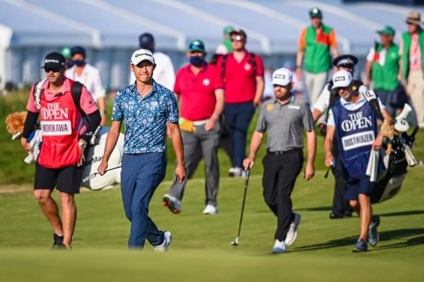 Collin Morikawa smiles as he walks up the 18th hole fairway during Day Four of the 149th The Open Championship at Royal St. Georges Golf Club on July...