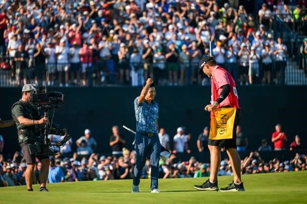 Collin Morikawa celebrates and smiles following his two stroke victory on the 18th hole green during Day Four of the 149th The Open Championship at...