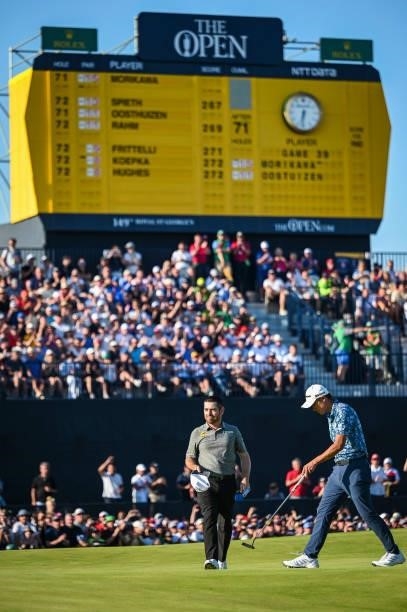 Louis Oosthuizen of South Africa tips his cap to fans in the grandstand on the 18th hole green during Day Four of the 149th The Open Championship at...