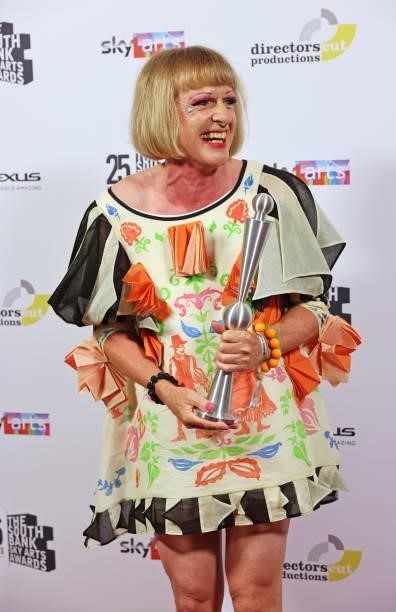 Grayson Perry, accepting the Outstanding Achievement Award, poses in the winners room at the South Bank Sky Arts awards at The Savoy Hotel on July...