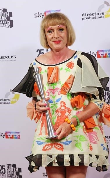Grayson Perry, accepting the Outstanding Achievement Award, poses in the winners room at the South Bank Sky Arts awards at The Savoy Hotel on July...