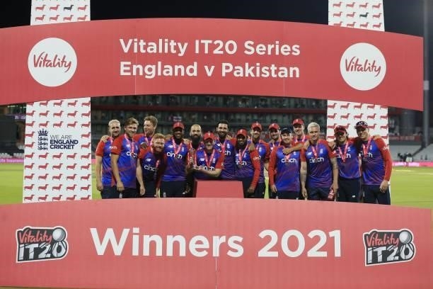 England's Captain Eoin Morgan , with teammates, raises the winner's trophy following the third T20 international cricket match between England and...