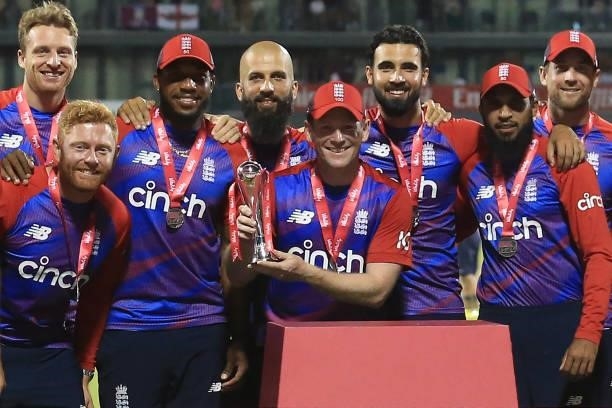 England's Captain Eoin Morgan , with teammates, raises the winner's trophy following the third T20 international cricket match between England and...
