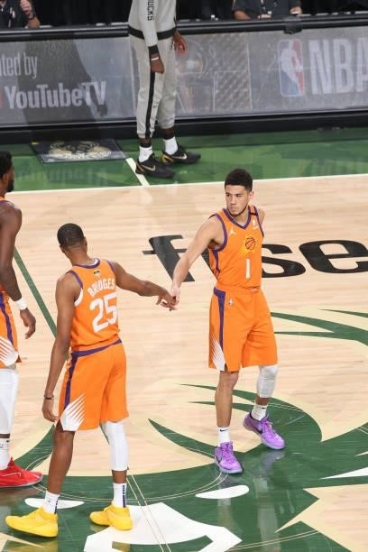 Mikal Bridges and Devin Booker of the Phoenix Suns embrace before Game Six of the 2021 NBA Finals on July 20, 2021 at the Fiserv Forum in Milwaukee,...