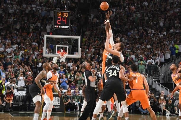 Brook Lopez of the Milwaukee Bucks and Deandre Ayton of the Phoenix Suns reach for the tip off during Game Six of the 2021 NBA Finals on July 20,...