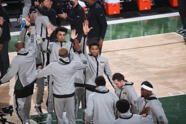 Giannis Antetokounmpo of the Milwaukee Bucks high fives his teammates before Game Six of the 2021 NBA Finals on July 20, 2021 at the Fiserv Forum in...