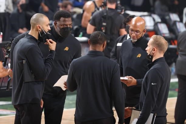 Head Coach Monty Williams of the Phoenix Suns talks with the coaching staff during Game Six of the 2021 NBA Finals on July 20, 2021 at the Fiserv...