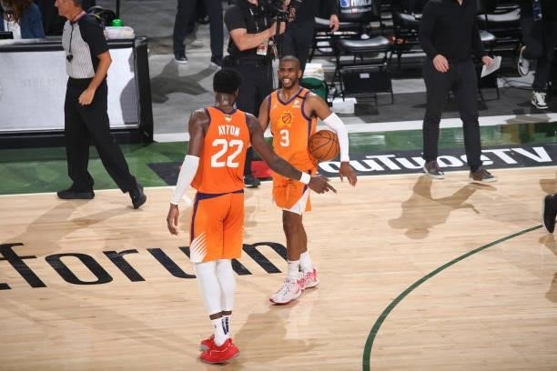 Deandre Ayton and Chris Paul of the Phoenix Suns embrace during Game Six of the 2021 NBA Finals on July 20, 2021 at the Fiserv Forum in Milwaukee,...