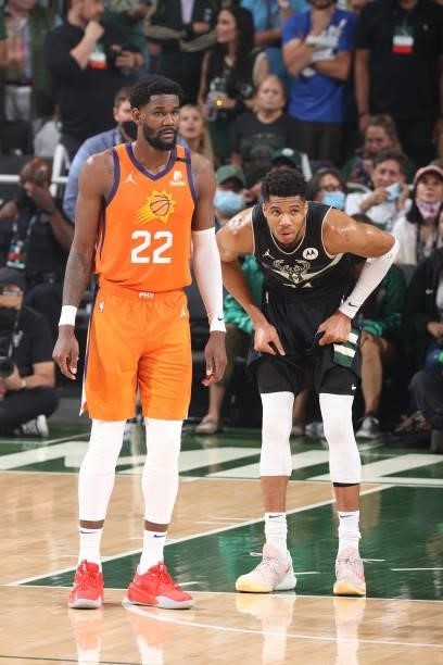 Deandre Ayton of the Phoenix Suns and Giannis Antetokounmpo of the Milwaukee Bucks look on during Game Six of the 2021 NBA Finals on July 20, 2021 at...