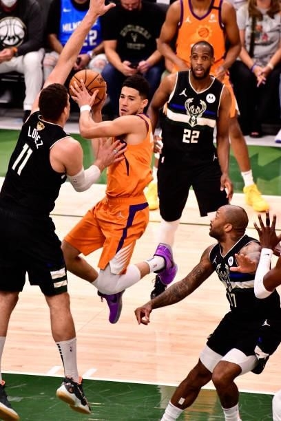 Devin Booker of the Phoenix Suns looks to pass the ball against the Milwaukee Bucks during Game Six of the 2021 NBA Finals on July 20, 2021 at the...