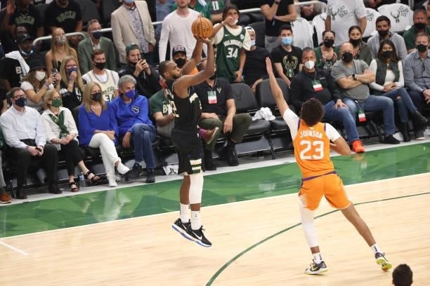 Khris Middleton of the Milwaukee Bucks shoots a three point basket against the Phoenix Suns during Game Six of the 2021 NBA Finals on July 20, 2021...