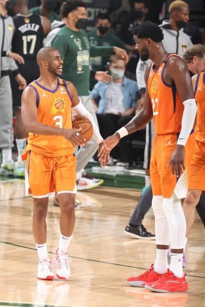 Chris Paul talks with Deandre Ayton of the Phoenix Suns during Game Six of the 2021 NBA Finals on July 20, 2021 at the Fiserv Forum in Milwaukee,...