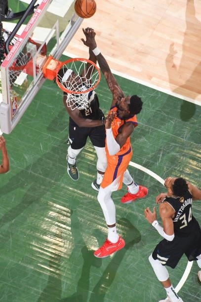 Jrue Holiday of the Milwaukee Bucks and Deandre Ayton of the Phoenix Suns fight for the rebound during Game Six of the 2021 NBA Finals on July 20,...