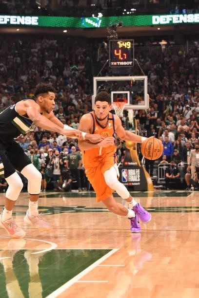 Devin Booker of the Phoenix Suns handles the ball against Giannis Antetokounmpo of the Milwaukee Bucks during Game Six of the 2021 NBA Finals on July...