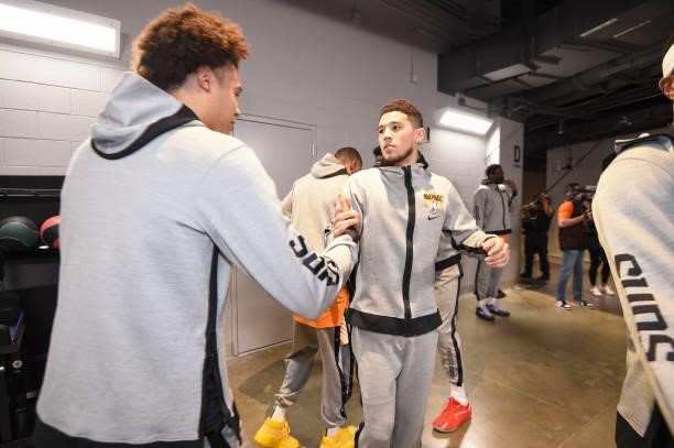 Cameron Johnson of the Phoenix Suns high fives Devin Booker of the Phoenix Suns before the game against the Milwaukee Bucks during Game Six of the...